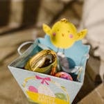 Charming Easter basket with colorful eggs and a cute chick decoration, perfect for holiday celebrations.